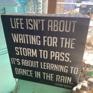Life isn’t about waiting for the storm Sign