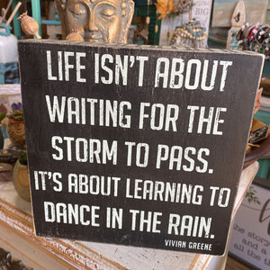 Life isn’t about waiting for the storm Sign